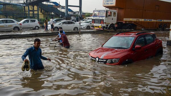 A Renault car is submerged in water on the Delhi-Gurugram highway after the street was flooded with rainwater.