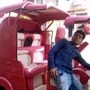 Pink auto rickshaw with convertible roof