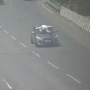 A screengrab of a video caught on a cam of the cop lying on the bonnet of the car of the accused driver. (@dailyreported/Twitter)