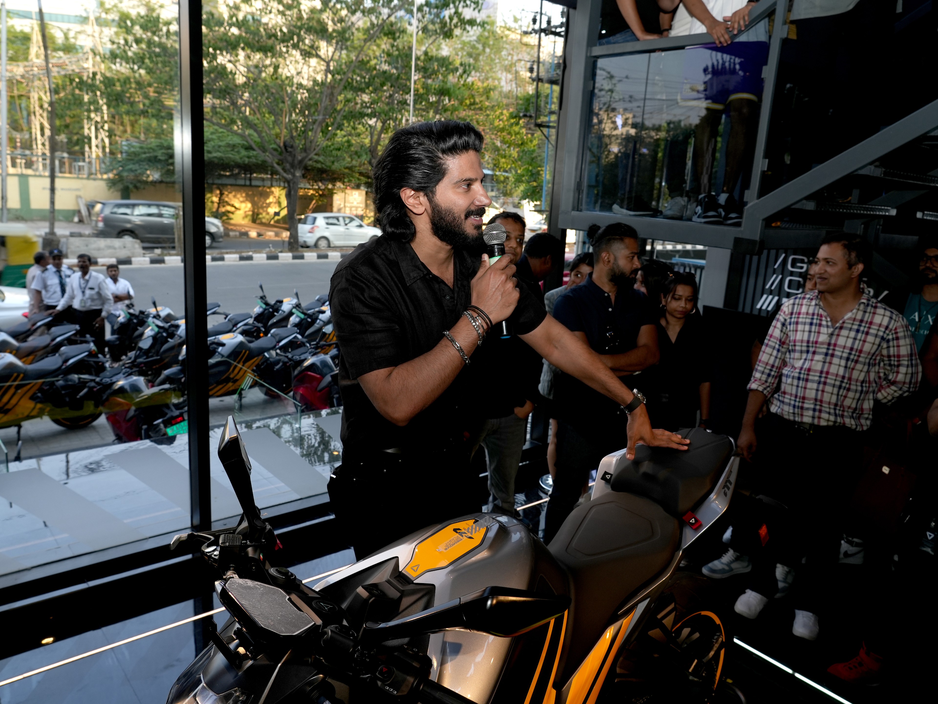 Dulquer Salmaan addresses the crowd at Ultraviolette's new experience center in Bangalore - UVH-01