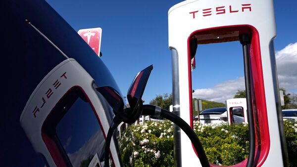 File photo of a Tesla EV charging at a company station. File photo of a Tesla EV charging at a company station.