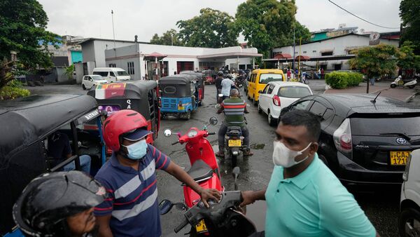File photo: People wait in a long queues to buy fuel for their vehicles at a filling station in Colombo, Sri Lanka.