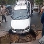 Road caved in in Lucknow leading a car to almost sink inside the crater. (Twitter/ Sumit Kumar)