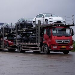 A truck transports new Tesla cars at its factory in Shanghai, China.