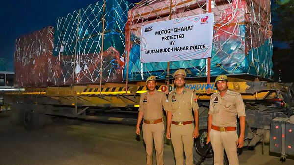 Police personnel stand near the first batch of equipment, including superbikes, ahead of the upcoming MotoGP Bharat 2023. Police personnel stand near the first batch of equipment, including superbikes, ahead of the upcoming MotoGP Bharat 2023.