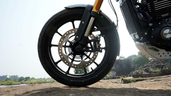 The 19-inch front wheel now gets a larger 320 mm disc brake. Triumph is not using sintered brake pads which have decreased the sharpness of the initial bite which is present on the Speed 400. However, this has been done to have a more progressive bite which should help while riding on off-road trails. The 19-inch front wheel now gets a larger 320 mm disc brake. Triumph is not using sintered brake pads which have decreased the sharpness of the initial bite which is present on the Speed 400. However, this has been done to have a more progressive bite which should help while riding on off-road trails.