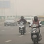 Commuters plying in Delhi on a road shrouded in smog amid hazy weather conditions. Delhi-NCR's air quality neared the emergency threshold this week, prompting ban on certain vehicles from plying to control pollution level. (PTI)