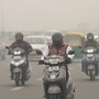Commuters plying in Delhi on a road shrouded in smog amid hazy weather conditions. Delhi-NCR's air quality neared the emergency threshold this week, prompting ban on certain vehicles from plying to control pollution level. (PTI)