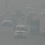Commuters make their way along a road amid heavy smoggy conditions in New Delhi on November 5. The Centre has implemented GRAP 4 in the national capital region. (AFP)