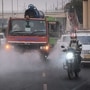 An Anti smog gun seen sprinkling water on road to curb pollution levels at Anand Vihar, in New Delhi. (Raj K Raj/Hindustan Times)