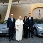Pope Francis is seen here with Volkswagen officials and the ID.3 and ID.4 electric vehicles.