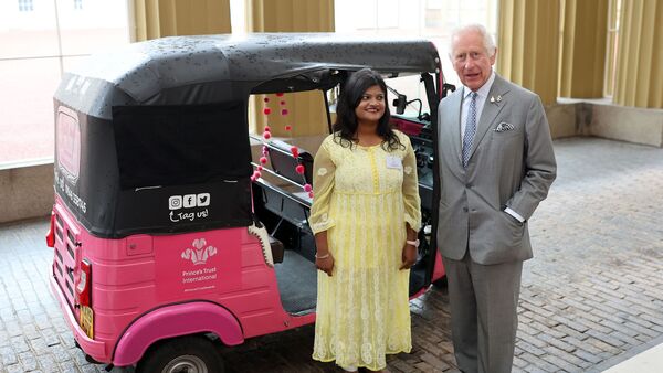 Pink electric auto rickshaw