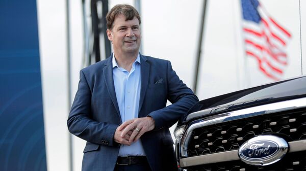 File photo: Ford CEO Jim Farley poses next to a 2021 Ford F-150 pickup truck at the Rouge Complex in Dearborn, Michigan.