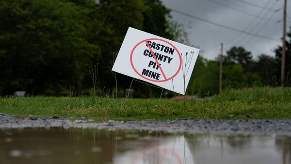 File photo of a sign against a planned lithium mine in Lincolnton, North Carolina. Lithium is a key component in batteries that are at the core of EVs. But lithium extraction process is a carbon-intensive exercise.