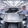 Porsche employees work on an assembly line at a company manufacturing facility in Leipzig, eastern Germany. (AFP)