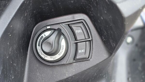 Just along the rotary knob, there are buttons to open the fuel door and the seat. There is a decent amount of storage under the seat. However, the fuel tank is quite small as it can hold only 5.5 litres.