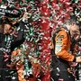 McLaren driver Oscar Piastri (R) is sprayed with champagne by third-placed Mercedes racer Lewis Hamilton on the podium after the Formula One Hungarian Grand Prix at the Hungaroring race track in Mogyorod near Budapest. (AFP)