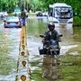 A vehicle commutes through the waterlogged road after heavy rainfall in New Delhi. The traffic police department has issued an advisory for commuters on roads to avoid congestion and waterlogging on Thursday as rains continue in different parts of the city.