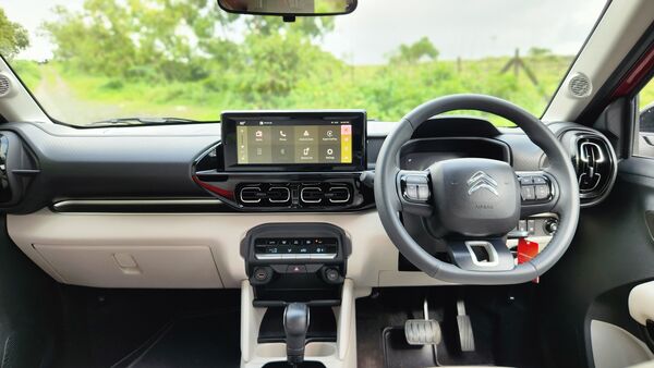 Interior of the Citroen Basalt looks simple yet premium with its linear approach to design layout. The steering wheel looks compact and premium depite its conventional look, while the free-standing touchscreen infotainment system with glossy black bezel grabs attention. The black and beige colour tone on the dashboard and interior makes the visual soothing. It also features automatic climate control, signature Citroen AC vents, a fully digital instrument cluster etc.