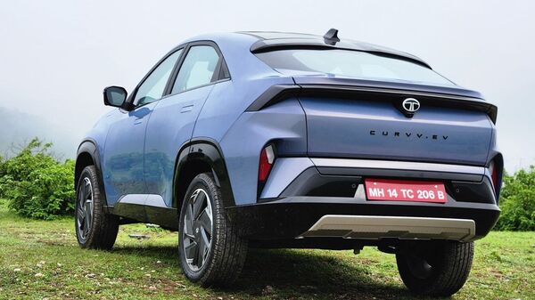 The small rear glass on the trunk door significantly hinders view from the rear-view mirror in the cabin of the vehicle. And while this is common on coupe vehicles, it is a bit too prominent on the Tata Curvv EV. The view from here, otherwise, is quite sporty, complete with a stretched light bar here too and a high rear bumper.