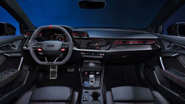 Inside the cabin, the Audi RS3 received optional carbon bucket front seats just like the BMW M2. These combine Nappa leather for the side bolsters with microfiber for the centres and a matte carbon rear. The regular sports seats come wrapped in Nappa leather. The steering wheel now comes with flat top and bottom sections. It gets a red 12 o'clock mark and quick-select buttons. Audi has also given the paddle shifter a flatter design.