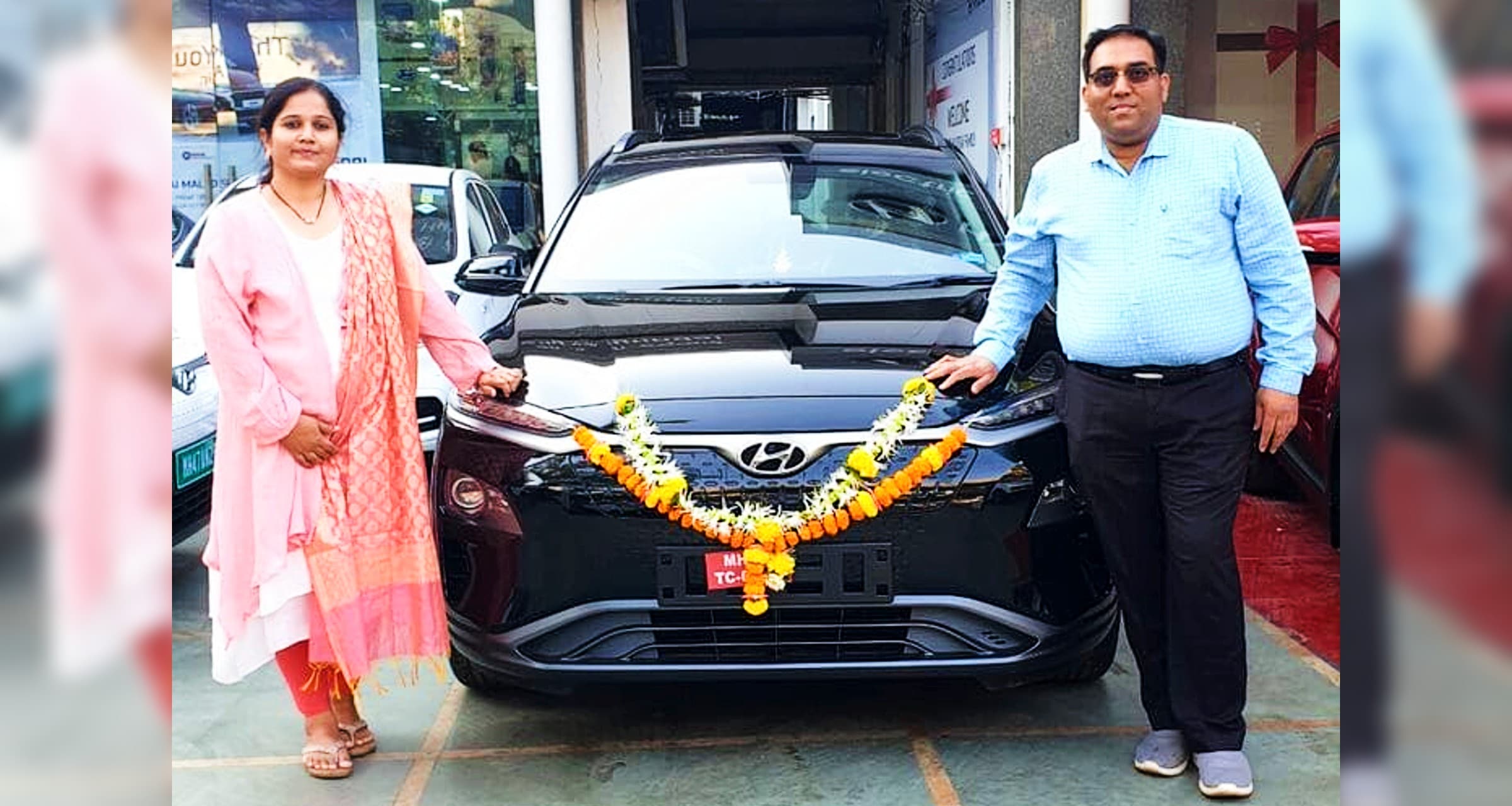 Dr Mukesh Patil with his wife receiving the delivery of his new Hyundai Kona EV in 2020