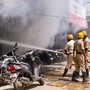 Firemen douse a fire at an Ola Electric showroom, in Kalaburagi. (PTI)