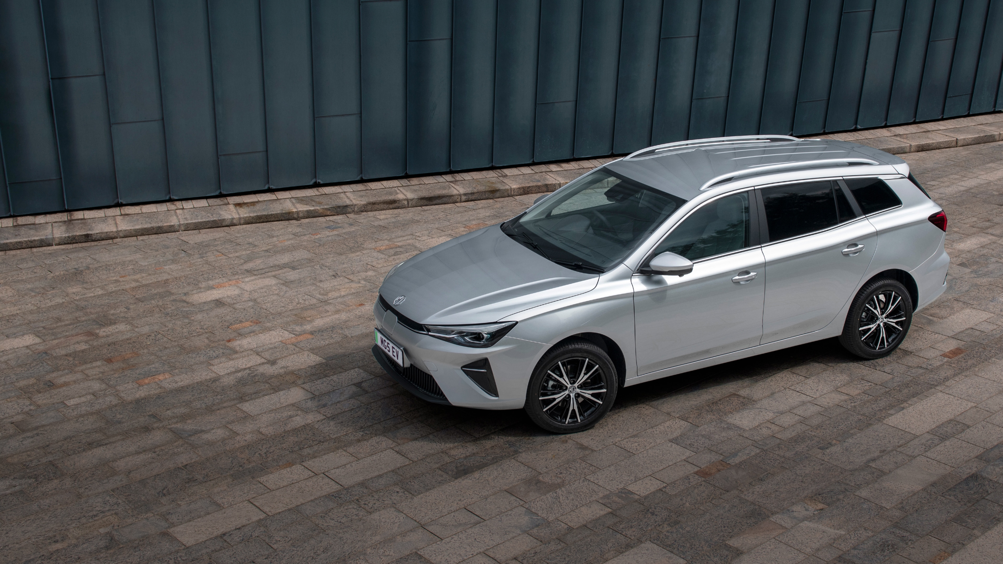 The MG5 EV Long Range is offered in two variants and it is touted as an all-electric family estate car with an expansive interior and large cargo area. It comes with a 61.1 kWh battery pack option and provides 402 km of single-charge range. 