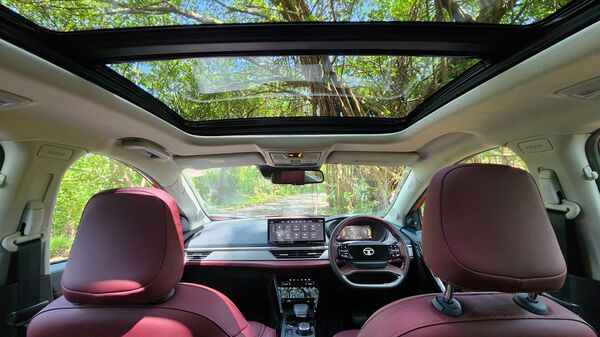 A look ahead from the back seats inside the Tata Curvv. A large panoramic sunroof is an obvious feature but even beyond it, the SUV comes fairly well kitted with comfort and convenience options.