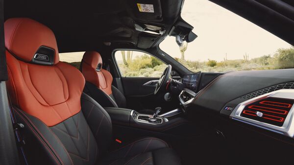 The black and red motif of the BMW XM Label Red extends to its interior. With a majority of the upholstery and interior done in black, contrasting red accents are used on the intstrument panel, centre console, door trim, and air vents. The upper sections of the seats are also done in Toronto Red.