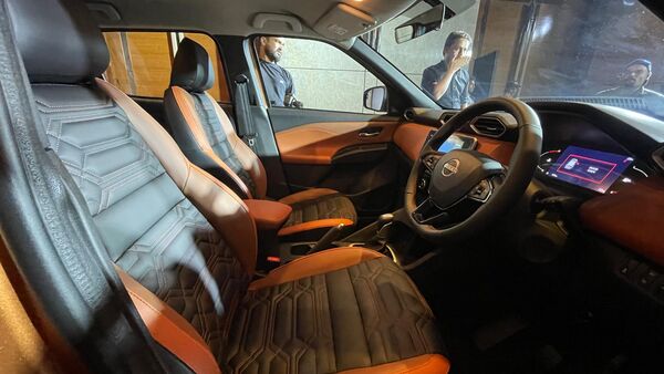 The cabin gets new faux leather upholstery while retaining the same layout. It also gets an auto-dimming IRVM with a frameless design