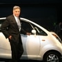 Chairman of India's giant Tata Group Ratan Tata poses in front of the Tata Nano, unveiled as the world's most affordable compact car, Mr Tata, who is credited with transforming the Tata Group into a globally renowned conglomerate, has died at age 86, the company said late on October 9, 2024.  (RAVEENDRAN / AFP)