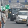 Volunteers are seen holding placards at a traffic signal in Delhi, urging motorists to turn ignition off while waiting for the signal to turn Green. (RAJ K RAJ / Hindustan Times))