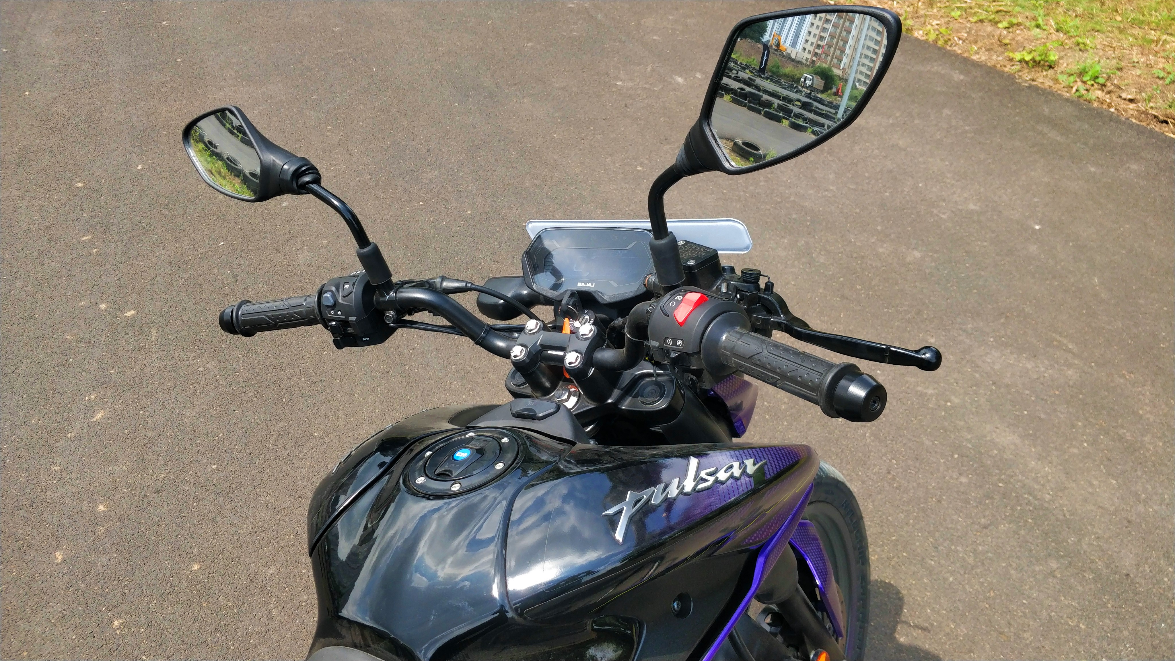 The 2024 Bajaj Pulsar N125 gets a neutral riding position with centre-set footpegs but the narrow handlebar makes it feel more commuter-like than sporty