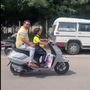The man smiles proudly as the kid rides a two-wheeler through the city. (@IdiotsRoads on Twitter)