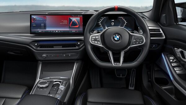 The cabin is upholstered in alcantara/sensatec combination with blue contrast stitching and features carbon fibre inserts along the dashboard and the centre console. The M340i further receives a unique 14.9-inch curved infotainment touchscreen.