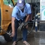 A CNG pump station attendant filling CNG gas in a car in Thane, Mumbai. (HT PHOTO)