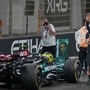 Lewis Hamilton waves towards the spectators after his last race for the Mercedes team after the Formula One Abu Dhabi Grand Prix at the Yas Marina Circuit in Abu Dhabi, United Arab Emirates. (AP)