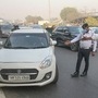 Gurugram Traffic Police personnel stop a car to check its documents. The city police have warned traffic violators who fail to pay challan within 90 days with strict action. (PTI)