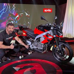 Brand ambassador John Abraham poses next to the newly-launched Aprilia Tuono 457 motorbike.