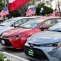 US flags fly outside a car dealership in Alhambra, California, on March 27, 2025. Automakers were battered on March 27 as stock markets fell on both sides of the Atlantic after US President Donald Trump announced significant tariffs on imported vehicles and parts, pressing ahead with tough trade policies many fear will spark a recession. (Photo by Frederic J. BROWN / AFP) (AFP)