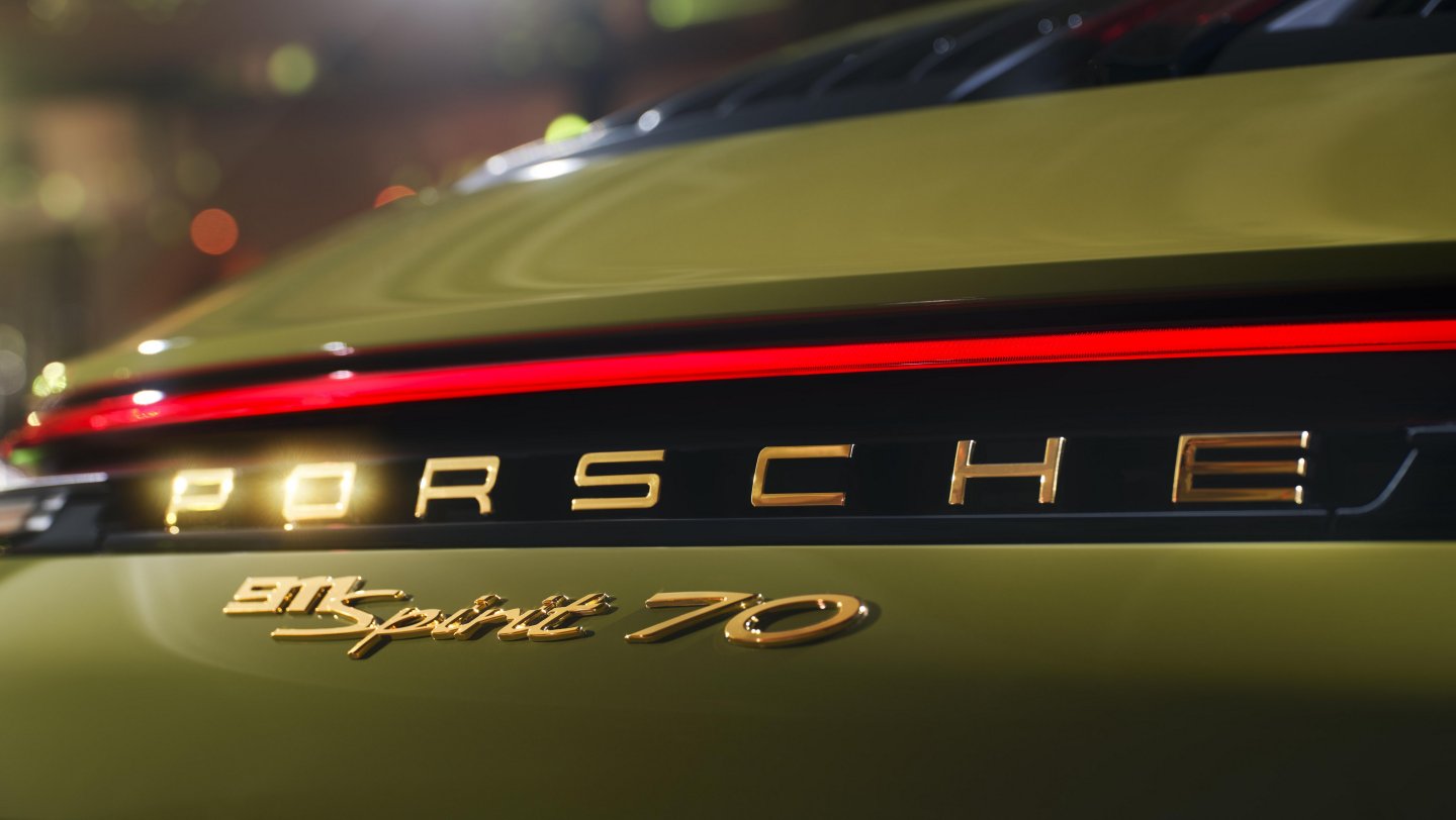 At the back of the car, there's Porsche and 911 Spirit 70 badging in a gold metallic finish.