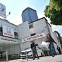 Pedestrians walk past a car dealership for Japanese automaker Honda Motor along a street in central Tokyo on May 13, 2025, ahead of the company's annual results announcement later in the day. (Photo by Richard A. Brooks / AFP) (AFP)
