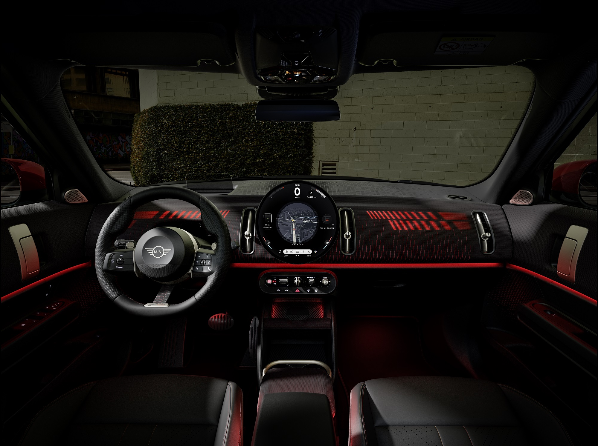 The cabin sports a black and red theme with JCW sport seats and steering wheel MINI Countryman E JCW Pack