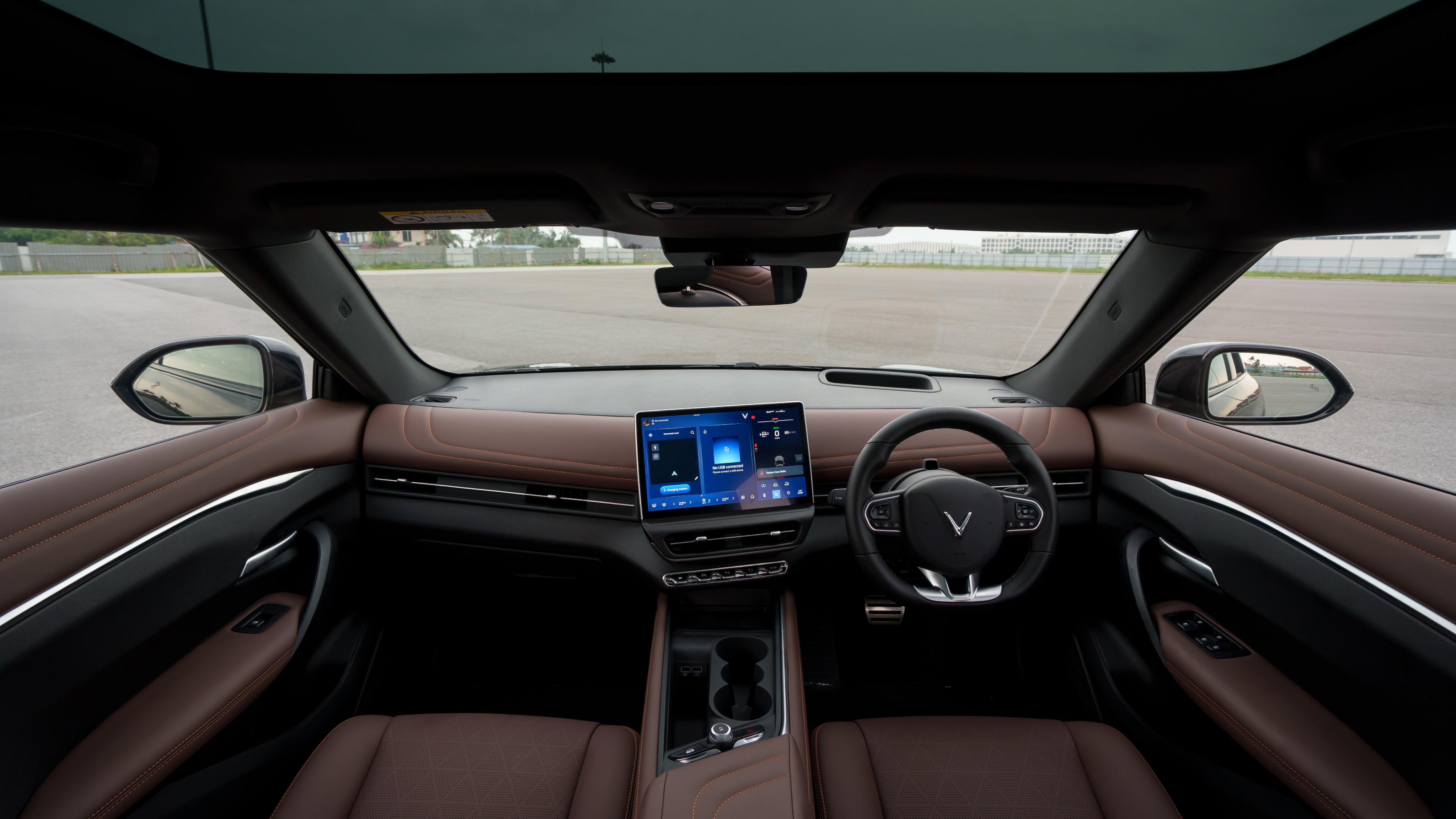The cabin gets a minimalist approach. There's no digital console, but you get a head-up display, whereas most of the controls are integrated into the 12.9-inch touchscreen infotainment system VinFast VF7 Review