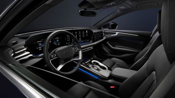 The cabin of the new A6 brings an expansive Softwrap layout and is loaded with tech for a digital driving experience 2026 Audi A6