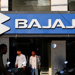 FILE PHOTO: Men exit a Bajaj Auto Ltd. dealer shop in New Delhi, India, October 15, 2024. REUTERS/Anushree Fadnavis/File Photo