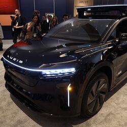 The Lucid Gravity-based robotaxi showcased at CES, featuring a roof-mounted sensor suite and a tech-focused cabin designed for autonomous ride-hailing.