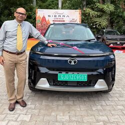 A Tata Sierra EV in Nainital Nocturne blue during customer delivery, reportedly the first unit delivered in Ahmedabad.