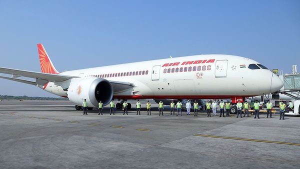 Airport staff stands wearing protective masks in front of the Air India plane before taking off to evacuate German nationals stranded amid coronavirus pandemic, in Hyderabad on Tuesday. (ANI Photo) Airport staff stands wearing protective masks in front of the Air India plane before taking off to evacuate German nationals stranded amid coronavirus pandemic, in Hyderabad on Tuesday. (ANI Photo)